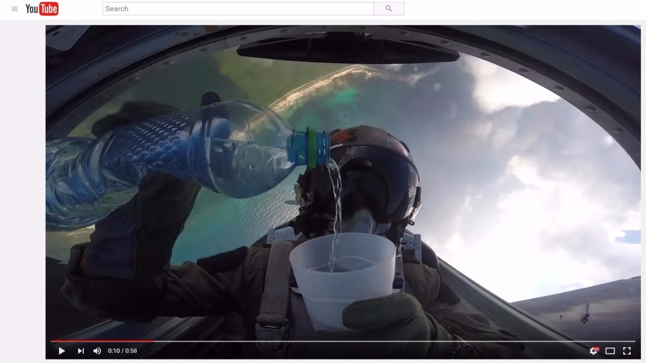 Fighter Pilot Drinks Water While Doing Barrel Rolls in a High Flying Jet