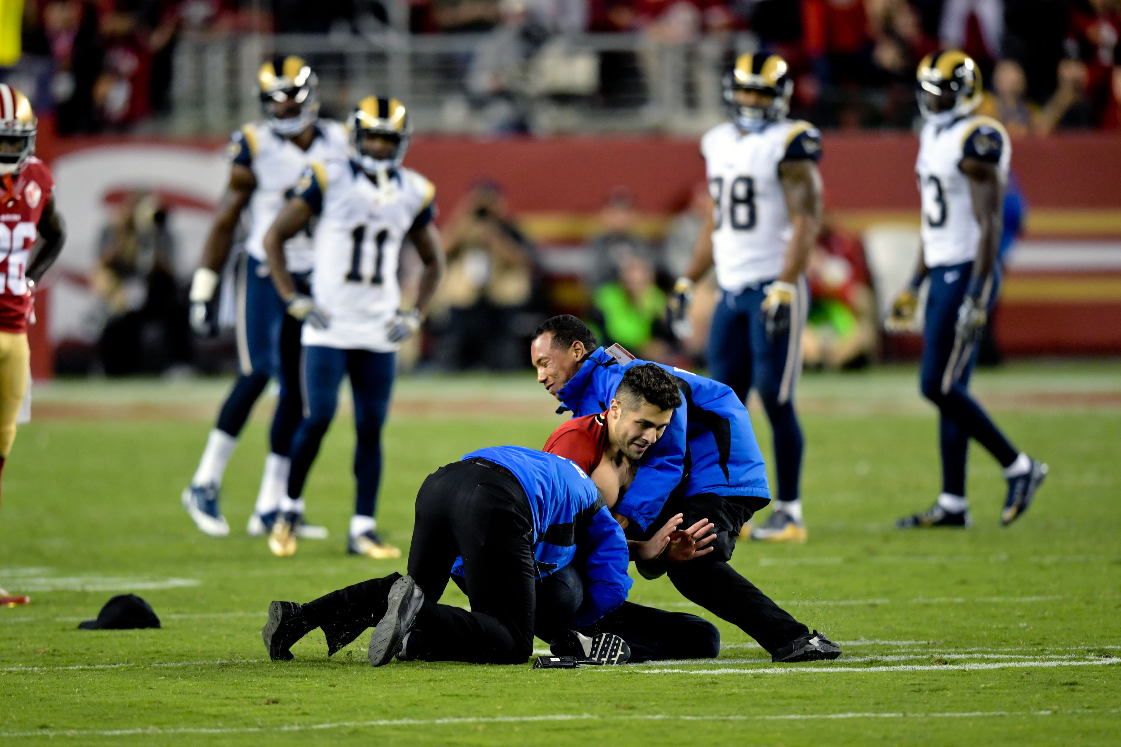 Rams players tackle fan who ran onto the field